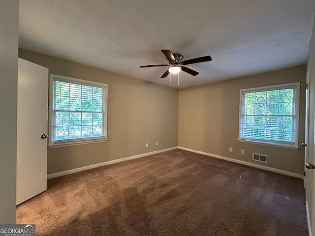 carpeted empty room featuring ceiling fan