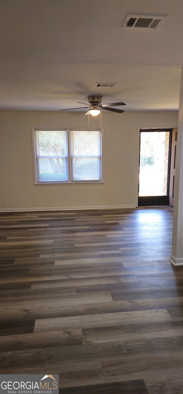 spare room featuring dark hardwood / wood-style floors and ceiling fan