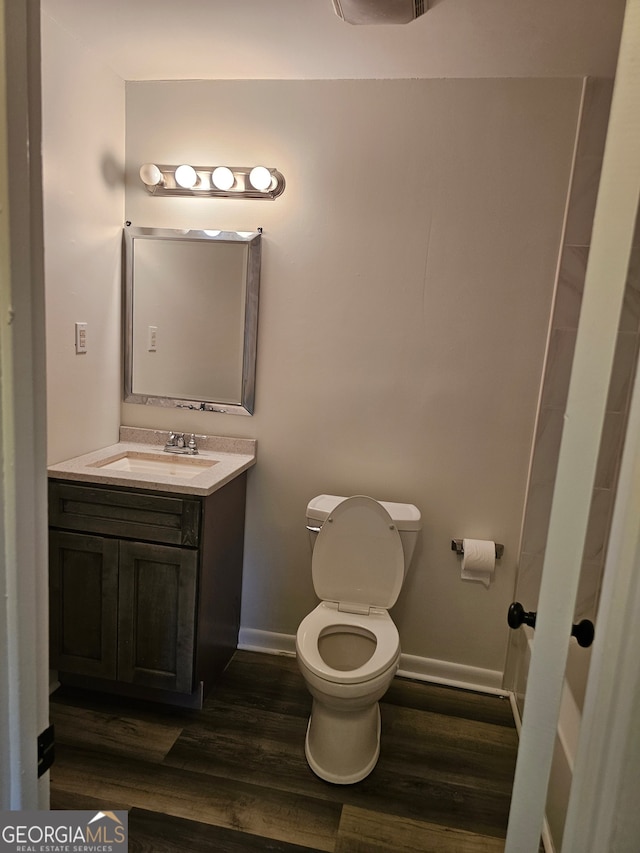 bathroom with vanity, hardwood / wood-style floors, and toilet