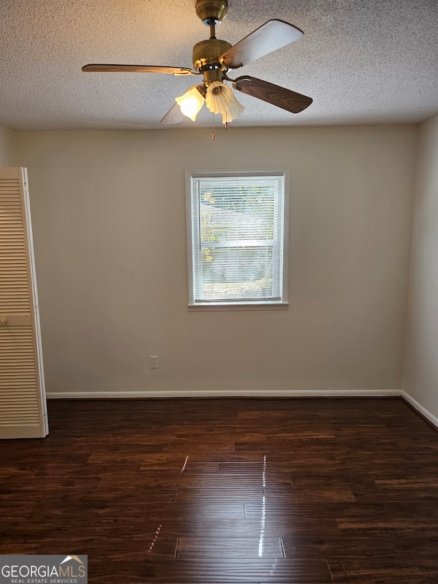 spare room featuring a textured ceiling, dark hardwood / wood-style floors, and ceiling fan