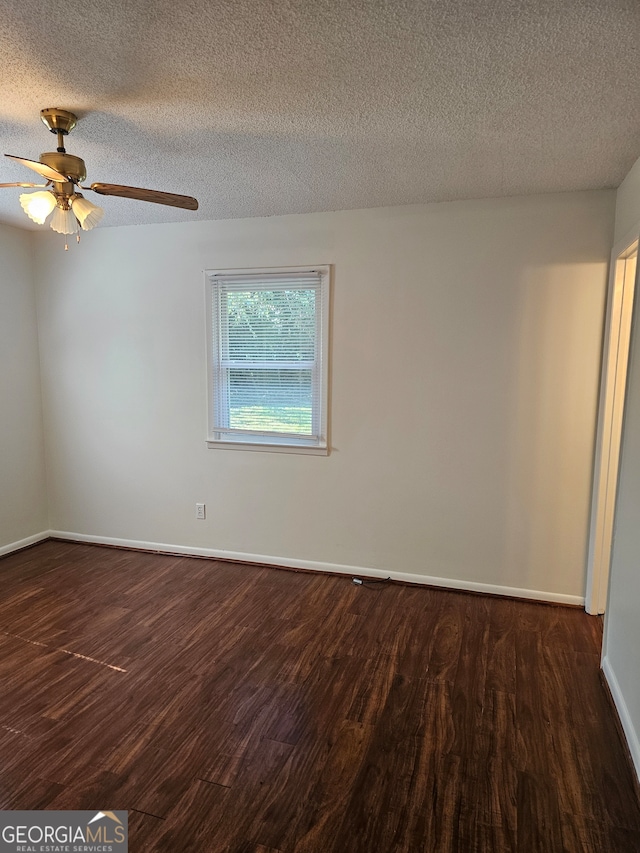 empty room with ceiling fan, a textured ceiling, and dark hardwood / wood-style floors