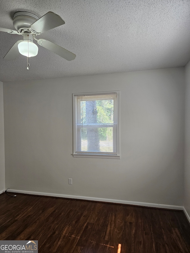 unfurnished room with dark wood-type flooring, ceiling fan, and a textured ceiling