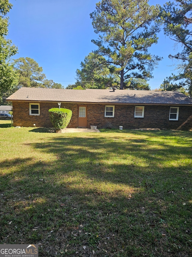 rear view of house with a yard