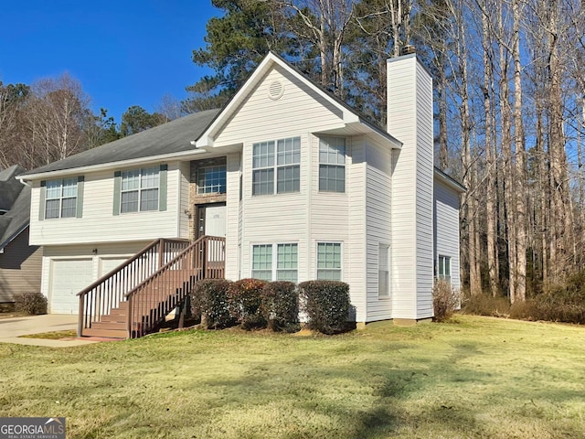 raised ranch with a garage and a front lawn