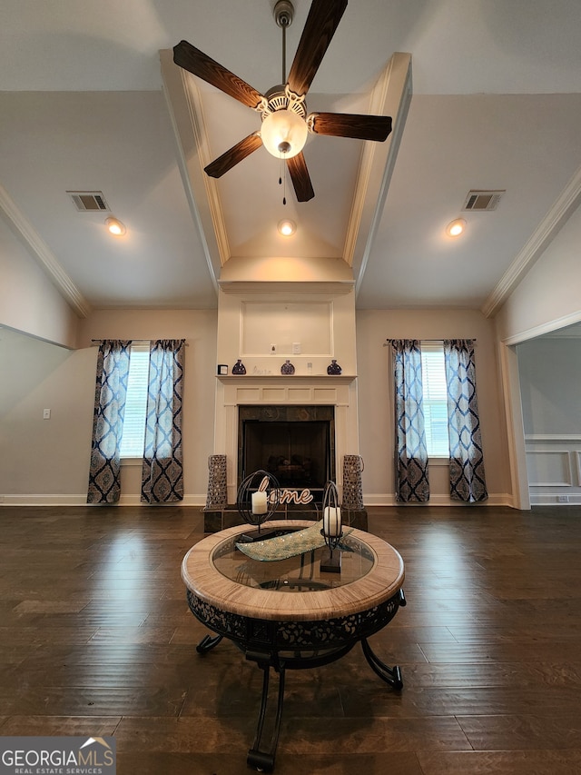 living room featuring crown molding, dark hardwood / wood-style flooring, and plenty of natural light