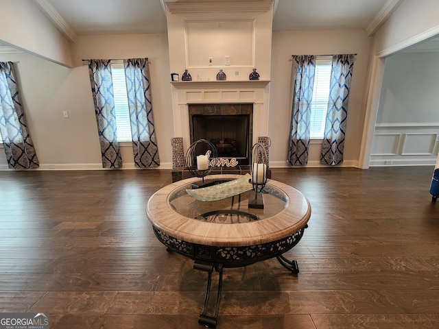 living area featuring ornamental molding and dark hardwood / wood-style flooring