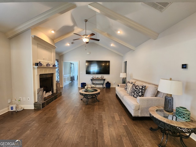 living room featuring vaulted ceiling with beams, a tile fireplace, ceiling fan, ornamental molding, and dark hardwood / wood-style floors