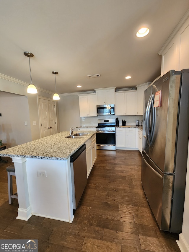 kitchen with white cabinetry, stainless steel appliances, dark wood-type flooring, sink, and decorative light fixtures