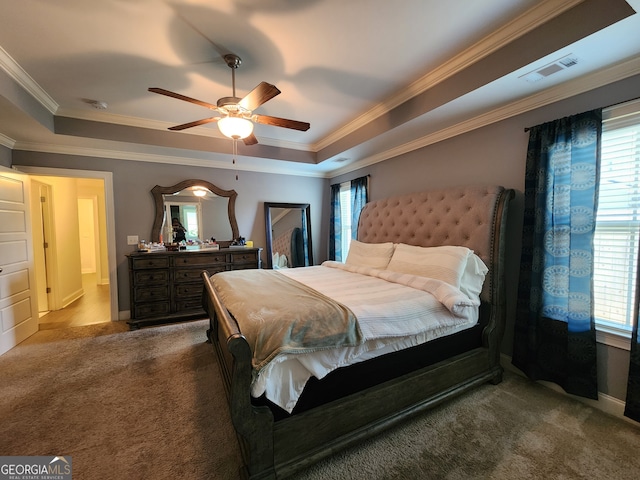 bedroom featuring ornamental molding, a raised ceiling, carpet flooring, and ceiling fan