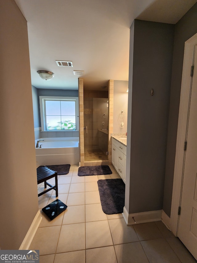 bathroom with vanity, plus walk in shower, and tile patterned flooring