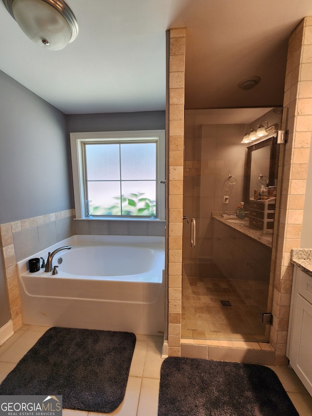 bathroom featuring vanity, plus walk in shower, and tile patterned flooring