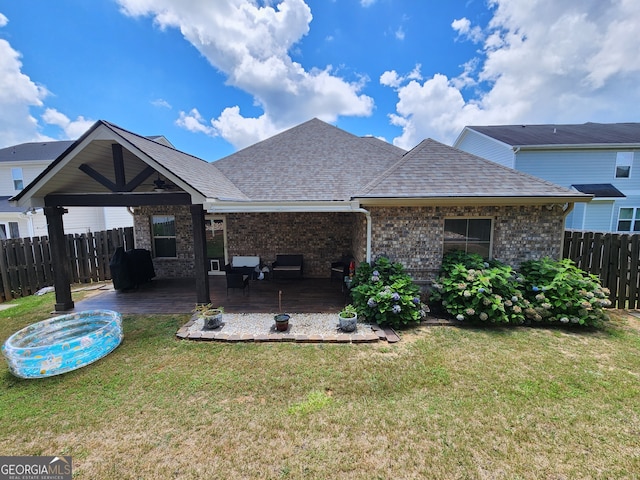 rear view of house featuring a yard and a patio