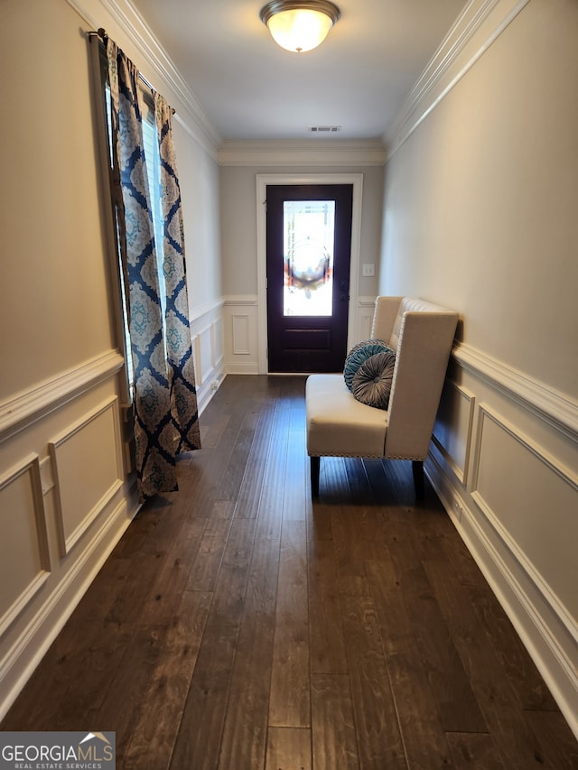 entryway featuring ornamental molding and dark hardwood / wood-style floors