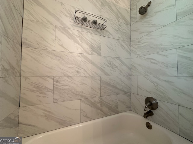 bathroom featuring tiled shower / bath