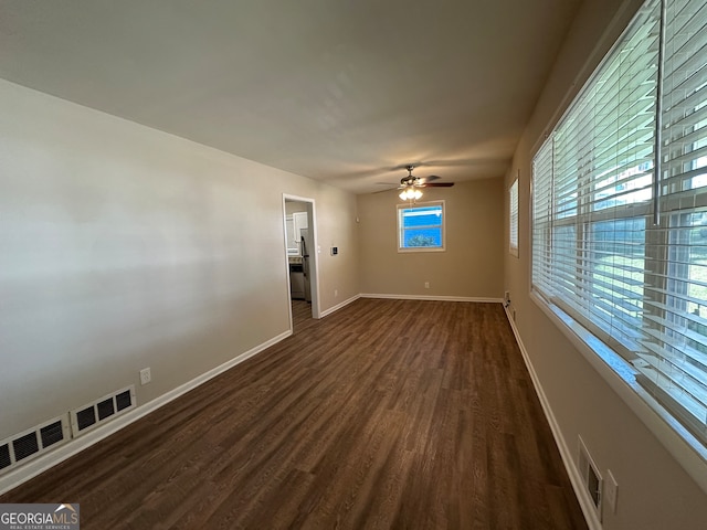 empty room featuring dark hardwood / wood-style floors and ceiling fan