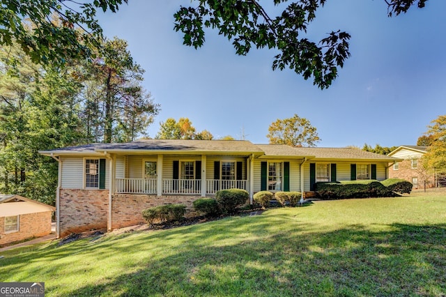 ranch-style house featuring a porch and a front lawn