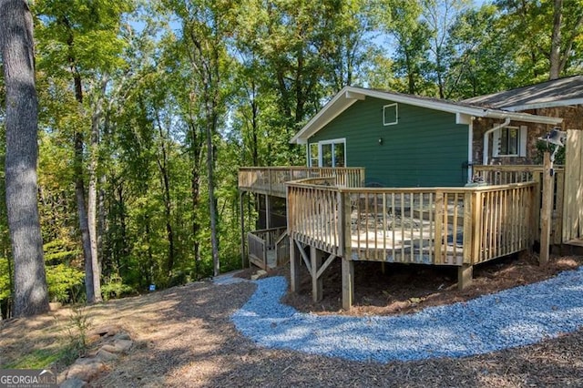 rear view of property featuring a deck