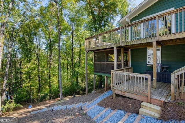 rear view of house featuring a deck