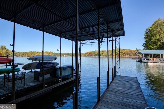 view of dock featuring boat lift and a water view
