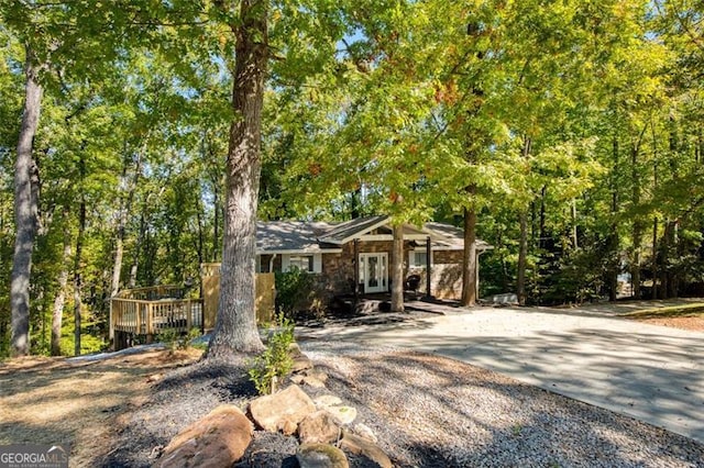 ranch-style home featuring driveway and french doors