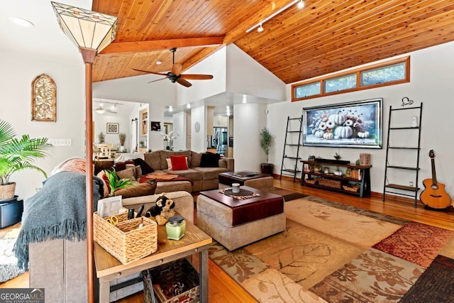 living room with beamed ceiling, wooden ceiling, hardwood / wood-style floors, high vaulted ceiling, and ceiling fan