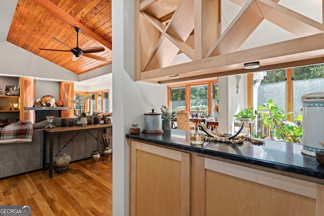 bar featuring wooden ceiling, lofted ceiling with beams, light brown cabinetry, light hardwood / wood-style floors, and ceiling fan