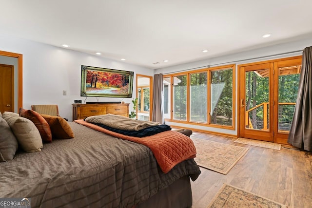 bedroom with light wood-type flooring and access to outside