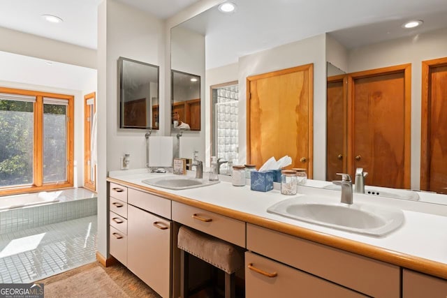 bathroom with vanity, a tub, and tile patterned flooring