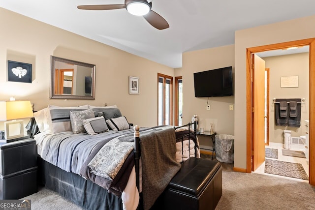 carpeted bedroom featuring connected bathroom and ceiling fan