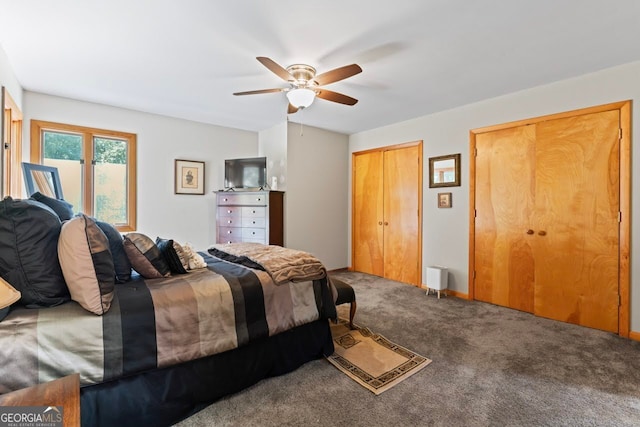 bedroom with ceiling fan, multiple closets, and carpet floors