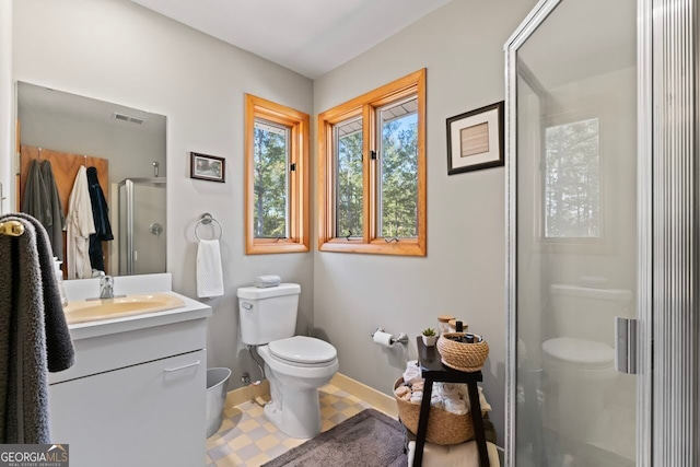 bathroom with vanity, toilet, and walk in shower