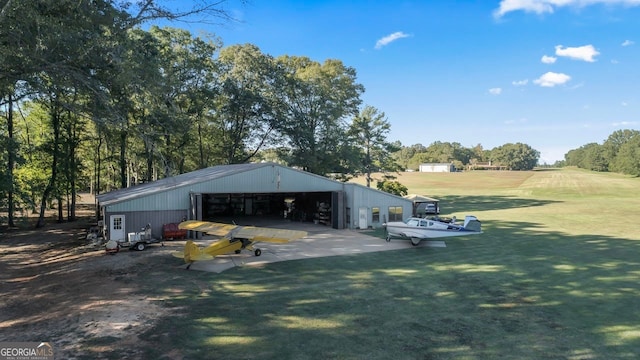 exterior space featuring a lawn and an outbuilding