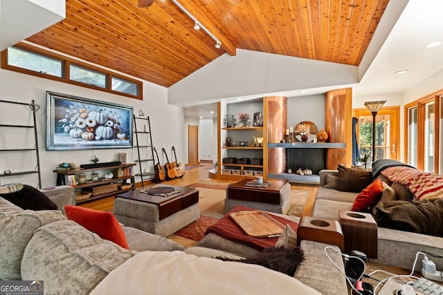 living room with beam ceiling, wooden ceiling, wood-type flooring, and plenty of natural light