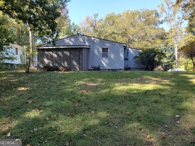 view of side of home featuring a yard