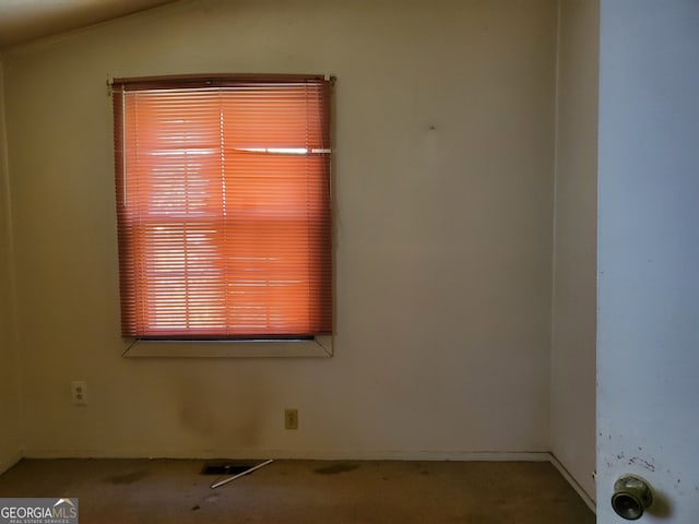 spare room with vaulted ceiling