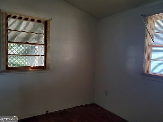 unfurnished room with dark hardwood / wood-style flooring