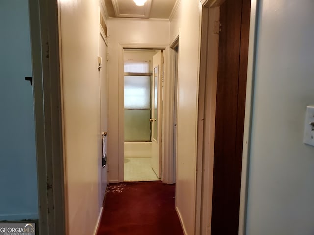 hall featuring crown molding and dark colored carpet