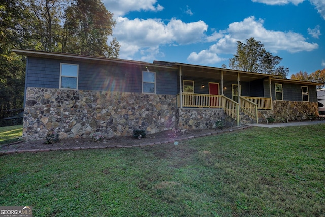 ranch-style house with covered porch and a front lawn