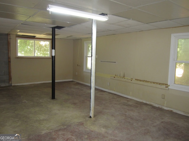 basement with a paneled ceiling