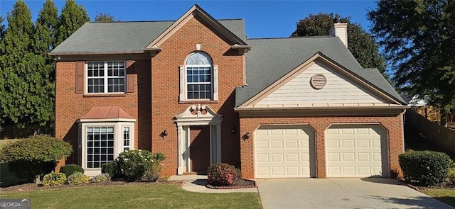 view of front facade featuring a garage and a front lawn