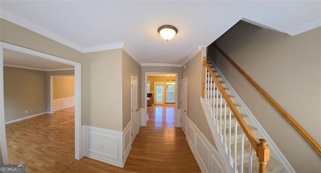 corridor featuring crown molding and hardwood / wood-style floors