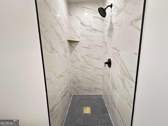 bathroom with a tile shower