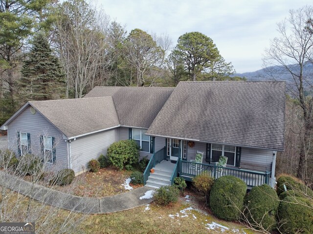 ranch-style home with a porch and a front lawn