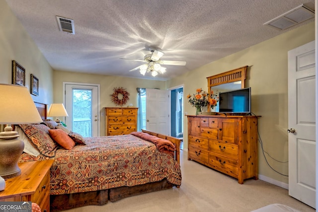 carpeted bedroom featuring ceiling fan, access to outside, and a textured ceiling