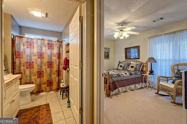 bedroom featuring light tile patterned floors and a textured ceiling