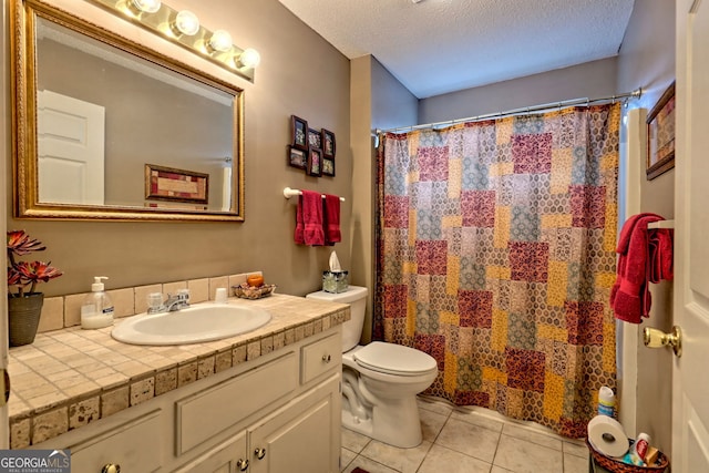 bathroom with tile patterned flooring, vanity, a textured ceiling, a shower with curtain, and toilet