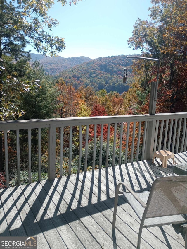 wooden deck featuring a mountain view