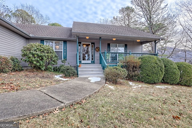 ranch-style home with a porch and a front lawn