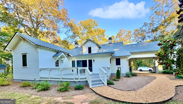 view of front of property featuring a wooden deck and a carport