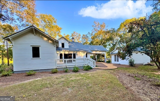 rear view of property featuring a yard